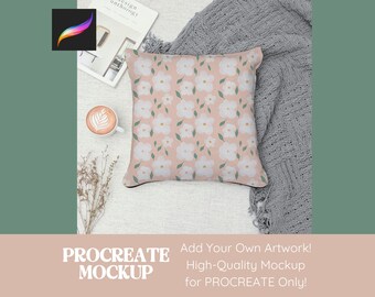 Peut inclure: Une maquette présentant un coussin rose à motif floral blanc. Le coussin est posé sur une surface blanche avec une couverture grise et un livre. Le texte "PROCREATE MOCKUP" est en bas de l'image. Le texte "Add Your Own Artwork! High-Quality Mockup for PROCREATE Only!" est également inclus.