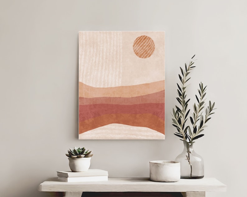 Puede incluir: Impresi&oacute;n de arte abstracto con un dise&ntilde;o minimalista que presenta un sol y l&iacute;neas onduladas superpuestas en tonos de naranja, rojo y marr&oacute;n sobre un fondo crema.