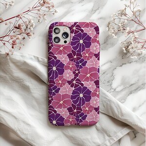 May include: A purple and pink floral phone case with a camera cutout.
