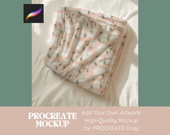 Peut inclure: Une maquette de couverture rose et blanche à motifs floraux pour Procreate. La couverture est pliée et placée sur un drap blanc.
