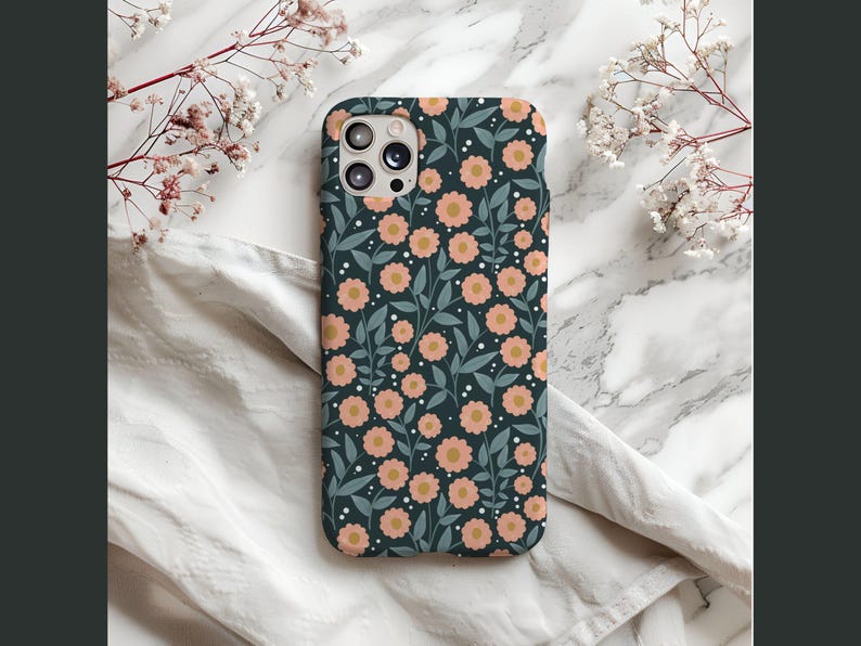 May include: A dark blue phone case with a floral pattern featuring pink flowers and green leaves.