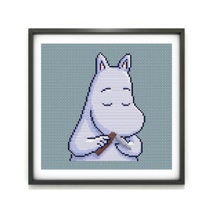 May include: A framed cross-stitch of a white cartoon character with closed eyes, holding a brown object and a silver object. The background is a light blue grid pattern. The frame is black.
