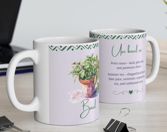 May include: White ceramic mug with a green and white design. The mug features a watercolour illustration of a potted basil plant and the text "Use basil in" with a list of uses for basil.