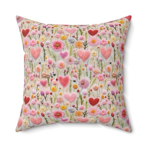 Pillow with design of hearts and flowers, looks like felt art, feels like suede