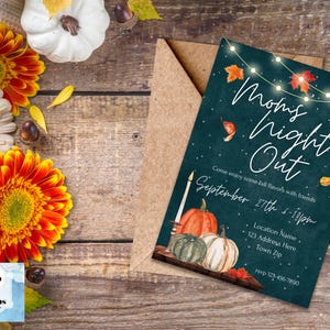 May include: A teal blue invitation with white text that reads "Mom's Night Out" with a string of lights and fall leaves. The invitation is for September 27th from 5-10pm. The text also includes a location name, address, and phone number.