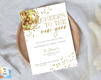 May include: New Year's Eve party invitation with a gold disco ball illustration and gold confetti on a white background. The text reads "Cheers to the New Year" and includes event details. The invitation is on a wooden plate.
