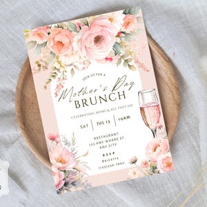 May include: Mother's Day brunch invitation with floral watercolour design. The invitation features a champagne glass, pink roses, and the text "Mother's Day Brunch". The invitation is on a light pink background.