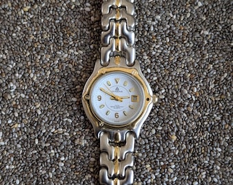 Dwukolorowy zegarek damski Dugena Swiss z datownikiem i luminescencyjnym wykończeniem w kolorze złotym i srebrnym, z 5 atm