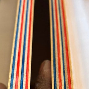 9 Layers of Vibrantly dyed maple veneer ply made with Red and Blue colours. Ply sheet measures 45x11x.05 inches. Sheet is polished smooth and finished with a thin layer of poly