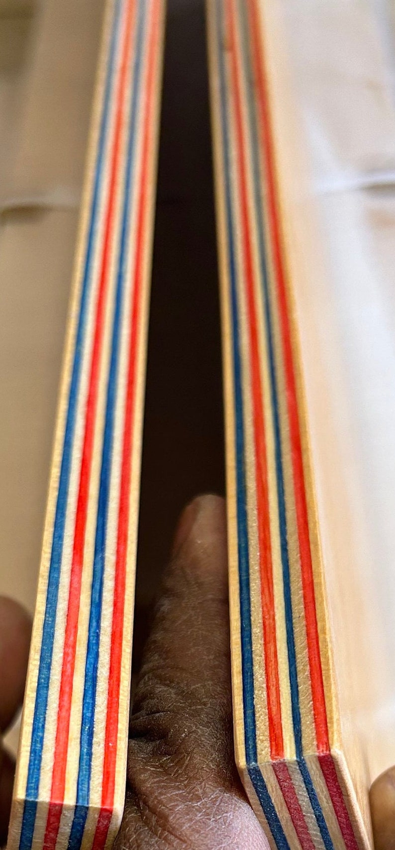 9 Layers of Vibrantly dyed maple veneer ply made with Red and Blue colours. Ply sheet measures 45x11x.05 inches. Sheet is polished smooth and finished with a thin layer of poly