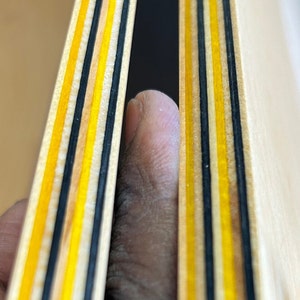 9 Layers of Vibrantly dyed maple veneer ply made with yellow and black colours. Ply sheet measures 45x11x.05 inches. Sheet is polished smooth and finished with a thin layer of poly