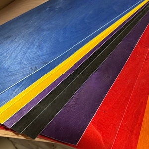 The vibrantly dyed Maple veneer used in the ply sheets on this listing left to right Blue, Yellow, Purple, Black,Purple, Red, Orange and natural