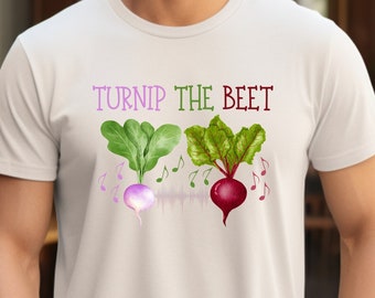 May include: A white t-shirt with a green turnip and a red beet with green leaves. The text "Turnip the Beet" is printed on the shirt.