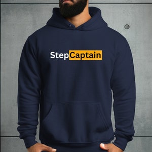 May include: A navy blue hoodie with a white text graphic that says "StepCaptain" in a yellow box.