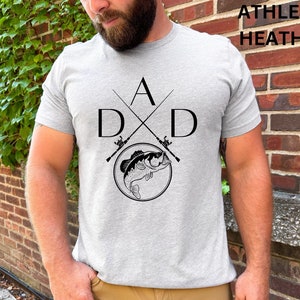 May include: A gray t-shirt with a black graphic of two crossed fishing rods and a bass fish. The text "A D X D" is printed on the shirt.