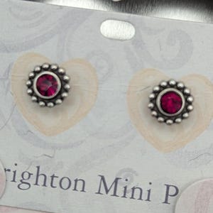 May include: A white ceramic mug with a black handle and the text "But First, Coffee" in a bold, black font. The mug is set against a neutral background, highlighting its simple design.