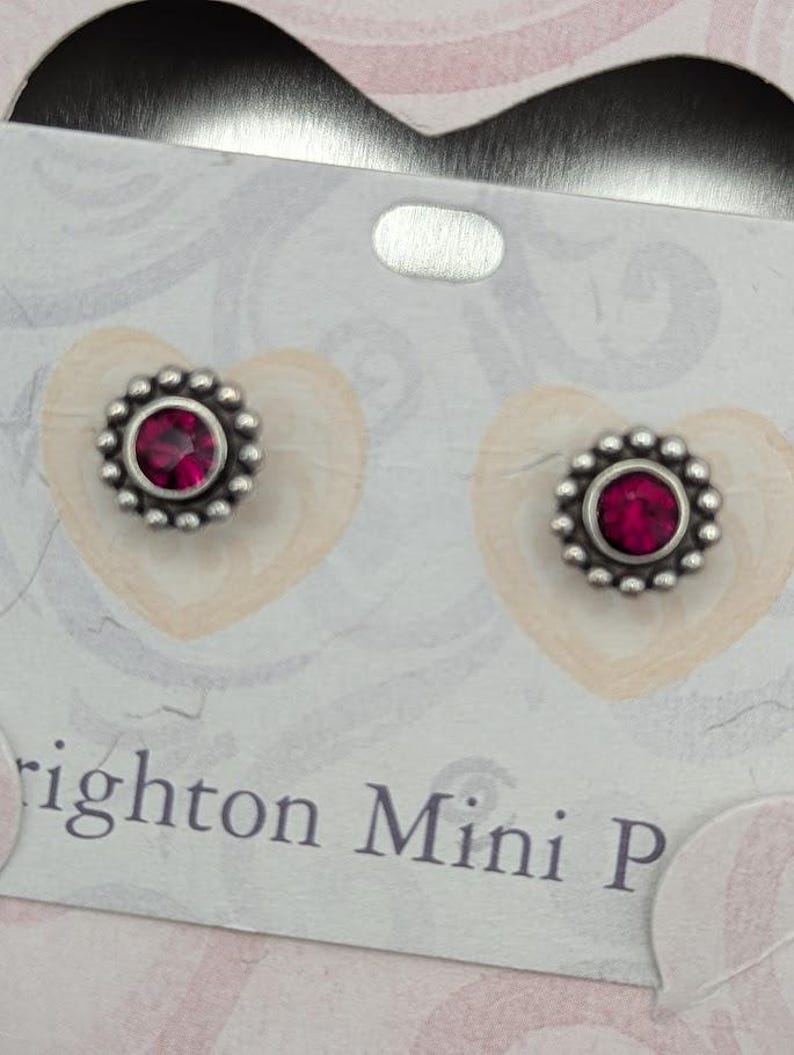 May include: A white ceramic mug with a black handle and the text "But First, Coffee" in a bold, black font. The mug is set against a neutral background, highlighting its simple design.