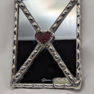 May include: A set of three ceramic mugs with a speckled, matte finish. The mugs are in shades of cream, light gray, and dark gray. Each mug has a simple, modern design and a rounded handle. The mugs are stacked on top of each other.