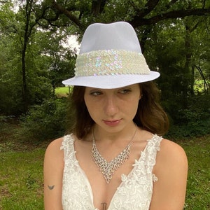 Wedding fedora hat white with hatband of white & iridescent sequins. one of a kind. the 32 inch veil is accented with lace.