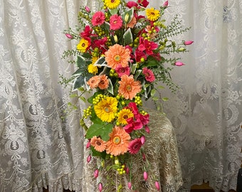 Cascading wedding bouquet made with high quality silk flowers yellow, peach and pink daisies and buds with greenery and fillers.