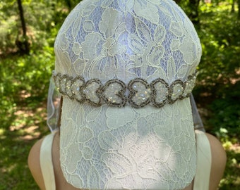 Lace bride, wedding cap embellished with sequin hearts on front and waist length veil attached with satin flowers