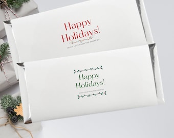May include: Two white gift tags with silver foil accents. The top tag has red text that says "Happy Holidays!" with a string of lights graphic. The bottom tag has green text that says "Happy Holidays!" with a holly border. Both tags have the text "Much Love from the Andrews" underneath the greeting.
