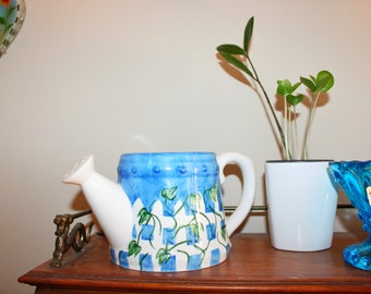 Blue and white checkered ceramic plant watering can