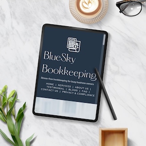 A digital tablet displaying the logo and services of BlueSky Bookkeeping, with tags for home, services, about us, and more. A cup of coffee, a plant, and eyeglasses are also visible.