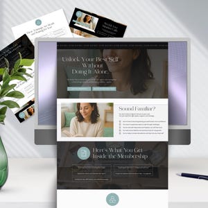 A desktop computer displaying a membership website for personal growth, featuring images and text about support and community. A green plant and a pen are nearby.