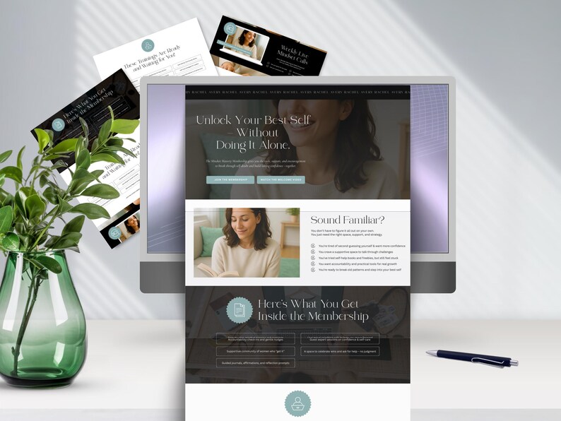 A desktop computer displaying a membership website for personal growth, featuring images and text about support and community. A green plant and a pen are nearby.