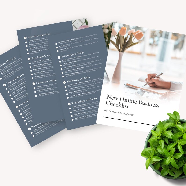 May include: A checklist for starting a new online business. The checklist is divided into sections such as Launch Preparation, Post-Launch Actions, E-Commerce Setup, Marketing and Sales, Technology and Tools, and Branding. The checklist is printed on blue paper and is laid out on a white surface with a potted plant and a hand writing on a notebook.
