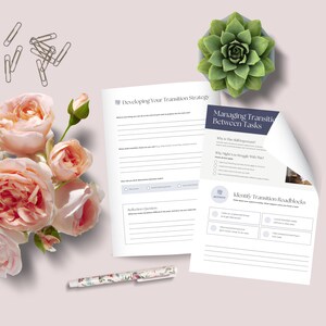 A workspace featuring two worksheets on managing transitions between tasks, surrounded by a bouquet of pink roses, a succulent plant, and a floral pen, set against a light background.