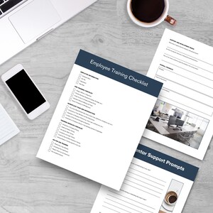 May include: A set of printed documents including an Employee Training Checklist, a Support and Development Needs form, and Mentor Support Prompts. The pages feature dark blue headers, black text, and checkboxes on a light gray wood grain surface.