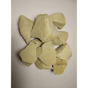 May include: A pile of pale yellow-green clay rocks. The rocks are irregular in shape and have a rough texture.