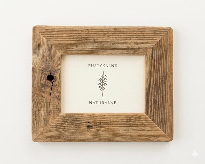 May include: A rectangular picture frame made of brown wood with a visible grain and a small knot on the left side. The frame contains a white insert featuring the text RUSTYKALNE, a line drawing of a wheat stalk, and the word NATURALNE.