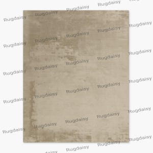 May include: A rectangular beige rug with a textured surface. The rug has a distressed appearance with lighter and darker areas, creating a subtle pattern. The word "Rugdaisy" is repeated diagonally across the rug.