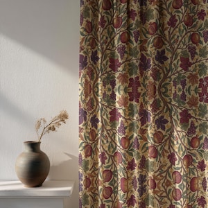 May include: A patterned curtain featuring a repeating design of pomegranates, grapes, and leaves in shades of red, purple, green, and brown against a cream background. The curtain is made of a thick fabric and is likely used for home decor.