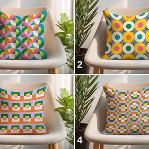 May include: Four decorative throw pillows with colorful geometric patterns. Each pillow is square and rests on a white chair. The patterns include circles, squares, and other shapes in various colors like pink, green, yellow, and orange.