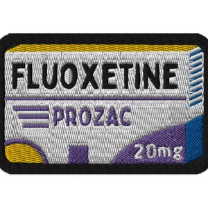 May include: Embroidered patch featuring the word FLUOXETINE above PROZAC, with a 20mg marking. The design includes a white background with purple and blue accents, and a black border.