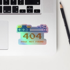 May include: A holographic sticker featuring a blue web browser window with arrows, a refresh button, and a search bar. The text "404 PAGE NOT FOUND" is in orange and white pixelated font.