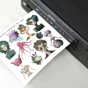 May include: A sheet of paper with illustrations of various underwater creatures, including fish, an octopus, and a seahorse. The paper is being printed from a black printer.