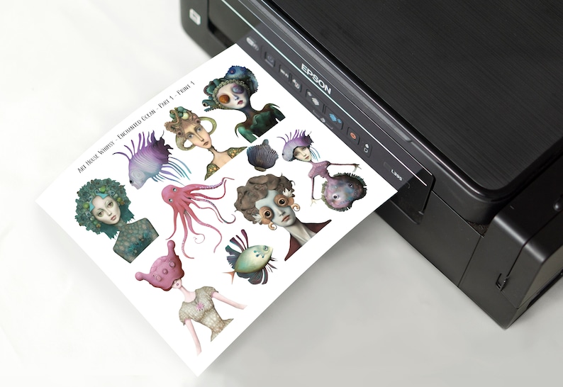 May include: A sheet of paper with illustrations of various underwater creatures, including fish, an octopus, and a seahorse. The paper is being printed from a black printer.