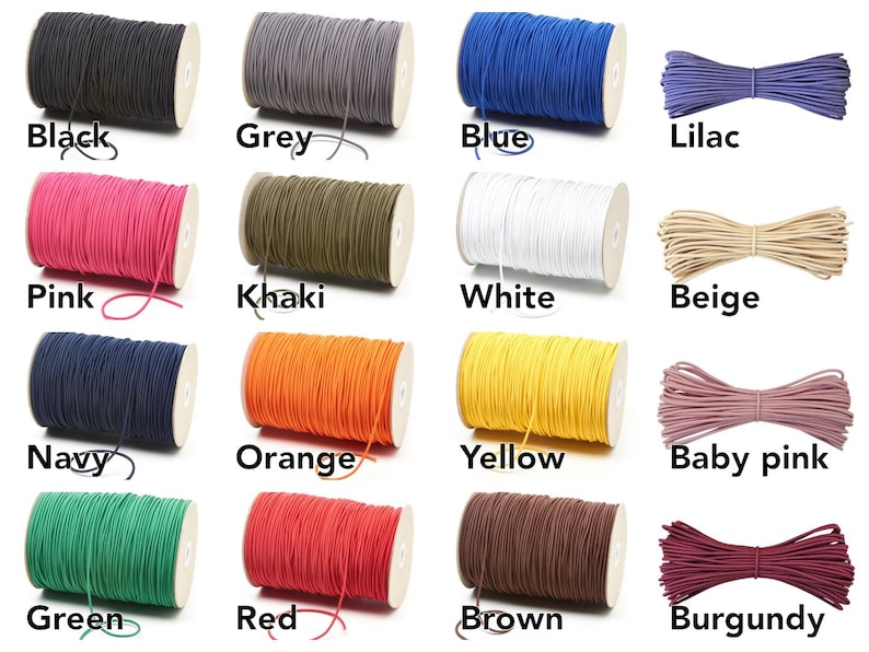 May include: A collection of spools of elastic cord in various colors, including black, grey, blue, lilac, pink, khaki, white, beige, navy, orange, yellow, baby pink, green, red, brown, and burgundy. Each spool is labeled with its color.