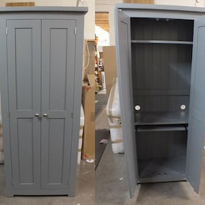 May include: A tall, grey cabinet with two doors. The doors are closed in the first image and open in the second image, revealing a shelf and a small pull-out shelf.