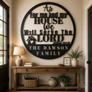 May include: A large circular black wall sign featuring the text As For me and my HOUSE We Will Serve The LORD JOSHUA 24:15 and THE DAWSON FAMILY with a house icon containing a heart. The sign is mounted on a wall above a wooden console table.