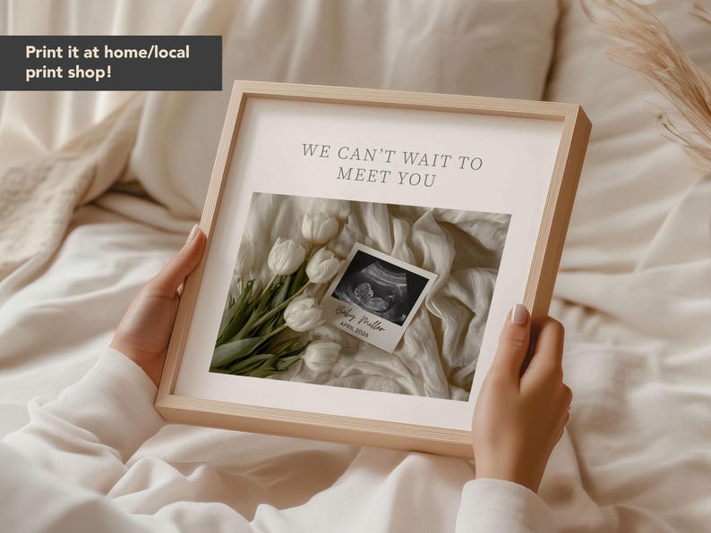 May include: A framed print with the text "WE CAN'T WAIT TO MEET YOU" above a sonogram image and a bouquet of white tulips. The print also includes the text "Baby Preller, April 2024".