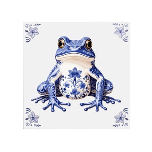 May include: A blue and white ceramic frog with a floral design. The frog is sitting on a white background.