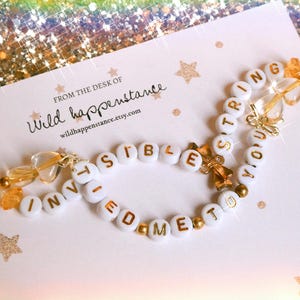 friendship bracelet • string • custom collection 8 • intertwined invisible gold thread hearts with tied to me bow charm bracelet