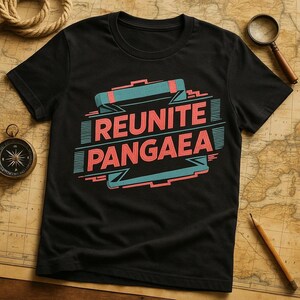 May include: Black t-shirt with the text "REUNITE PANGAEA" in a retro font. The design features a teal and red color scheme with a stylized banner and geometric shapes. The shirt is made of a soft material.