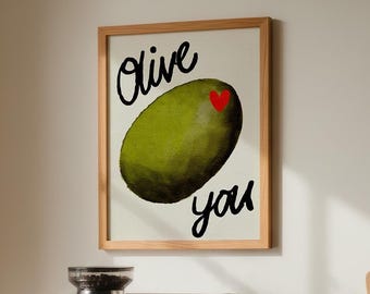 May include: A kitchen scene featuring a framed art print with the words "Olive you" and an olive illustration. A stainless steel espresso machine, two white mugs, and a wooden cutting board are on the countertop. Two glass jars with coffee beans are also visible.